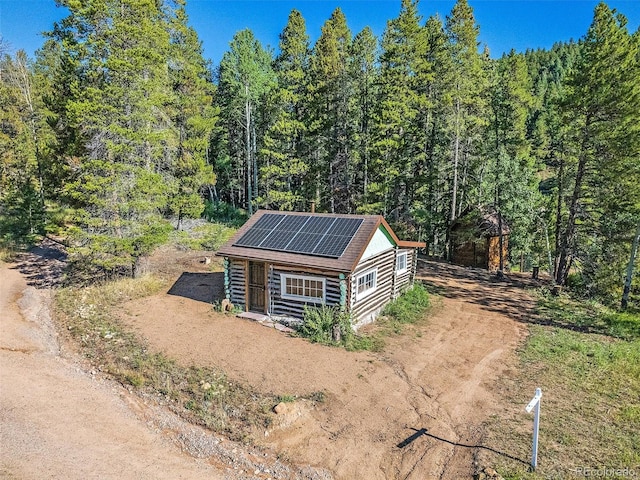 exterior space featuring a wooded view