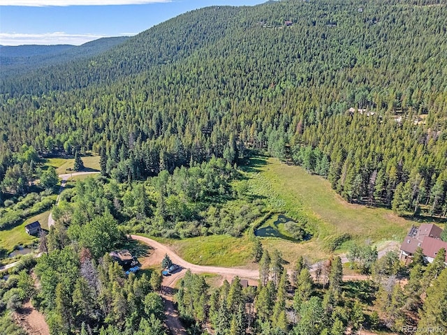 drone / aerial view with a forest view and a mountain view