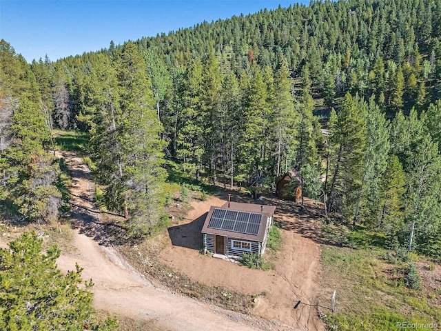 drone / aerial view featuring a view of trees