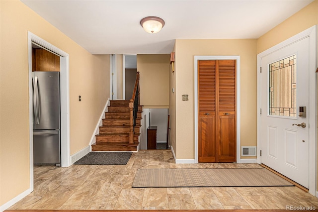 10009 Dodge Dr, Northglenn, CO 80260 - entrance foyer with baseboards and stairway