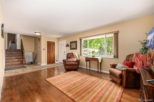 10009 Dodge Dr, Northglenn, CO 80260 - living room featuring wood finished floors and stairs