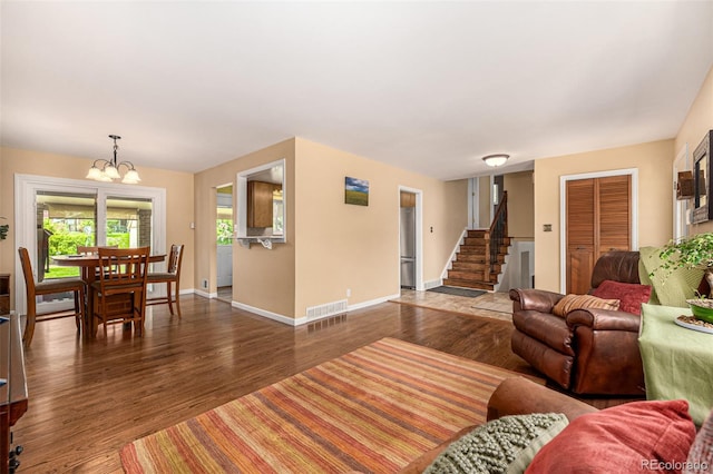10009 Dodge Dr, Northglenn, CO 80260 - living room featuring a chandelier, wood finished floors, and stairs