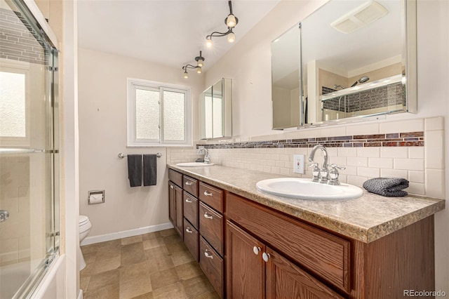 10009 Dodge Dr, Northglenn, CO 80260 - bathroom with tasteful backsplash, double vanity, and combined bath / shower with glass door