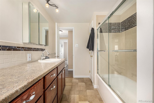 10009 Dodge Dr, Northglenn, CO 80260 - bathroom featuring vanity, shower / bath combination with glass door, and tasteful backsplash