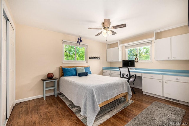 10009 Dodge Dr, Northglenn, CO 80260 - bedroom with dark wood-style flooring, built in study area, and a ceiling fan
