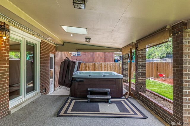 10009 Dodge Dr, Northglenn, CO 80260 - view of patio / terrace with a hot tub
