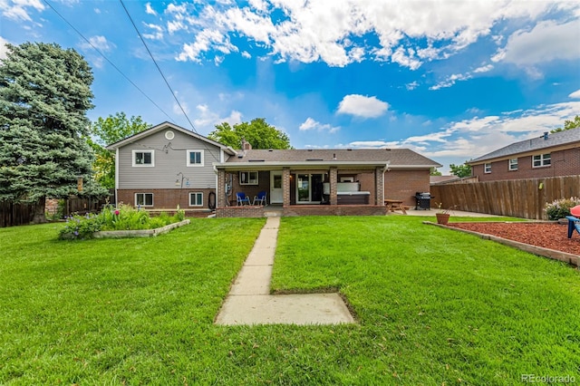 10009 Dodge Dr, Northglenn, CO 80260 - rear view of property with brick siding and a patio