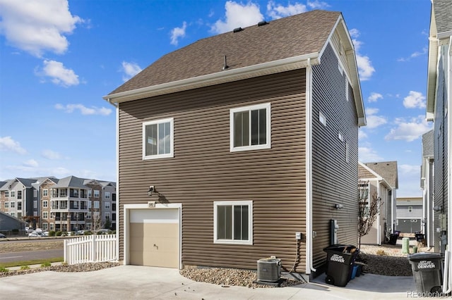 5383 Andes St, Denver, CO 80249 - back of house featuring a garage and driveway