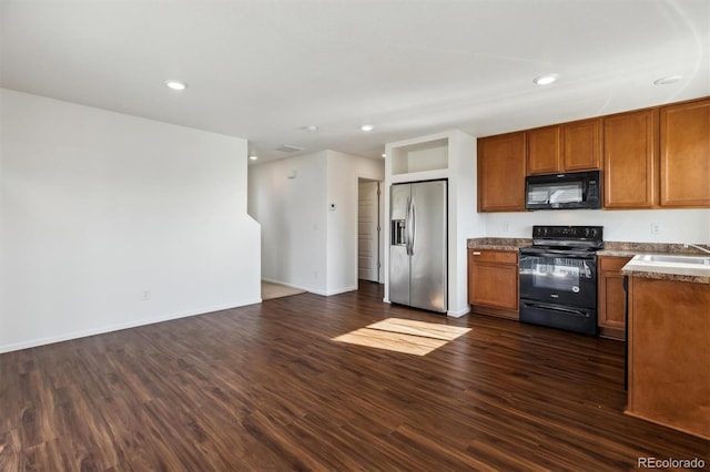 5383 Andes St, Denver, CO 80249 - kitchen with black appliances, brown cabinets, dark wood-type flooring, recessed lighting, and open floor plan