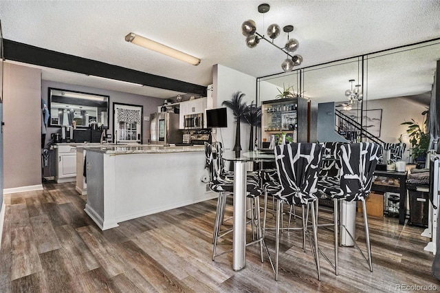 kitchen featuring stainless steel microwave, dark wood finished floors, smart refrigerator, and white cabinets