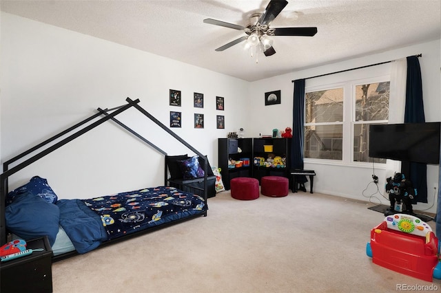 carpeted bedroom featuring a textured ceiling and a ceiling fan