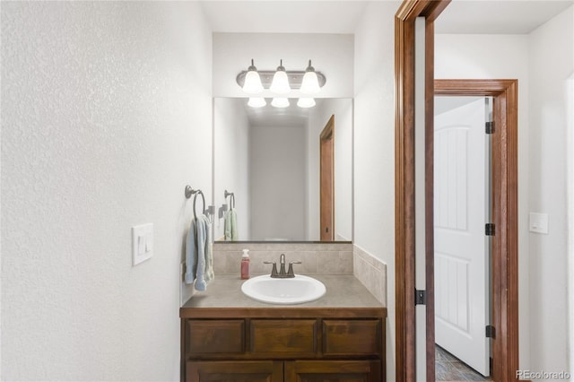 bathroom with vanity and a textured wall