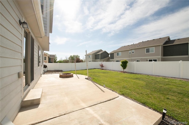 view of patio / terrace featuring an outdoor fire pit and a residential view