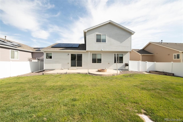 rear view of house featuring a patio area and solar panels