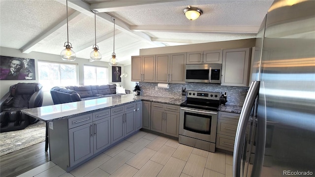 kitchen with lofted ceiling with beams, appliances with stainless steel finishes, open floor plan, decorative light fixtures, and a peninsula