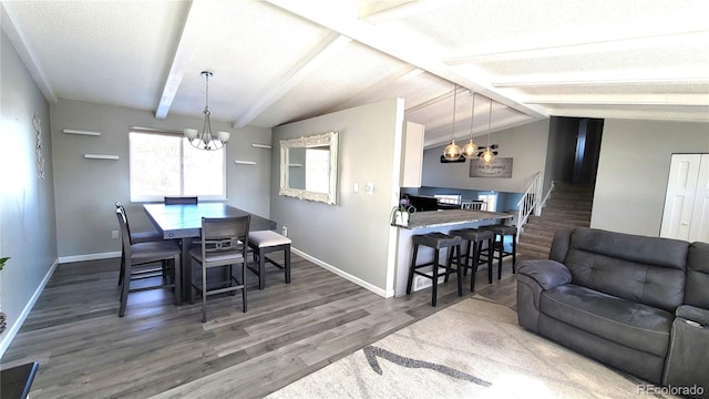 dining space with baseboards, stairway, wood finished floors, vaulted ceiling with beams, and a chandelier