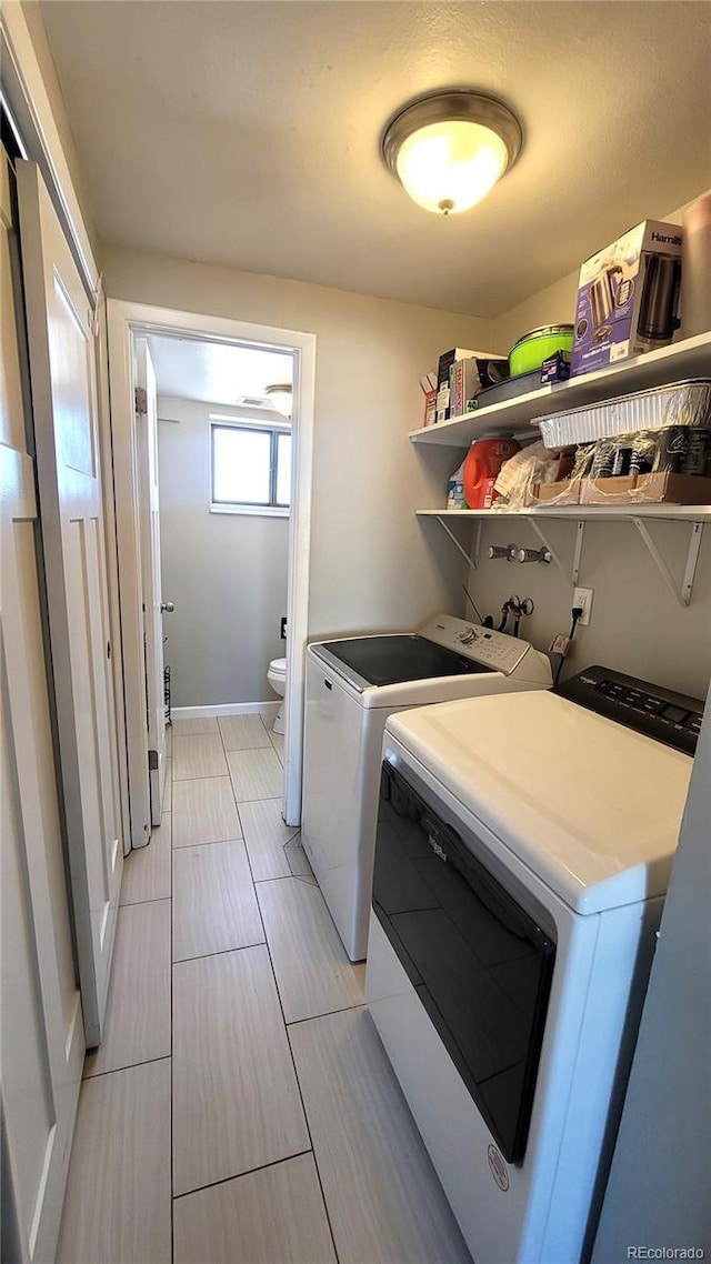 washroom with washing machine and clothes dryer