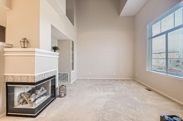 living room featuring light carpet and a fireplace