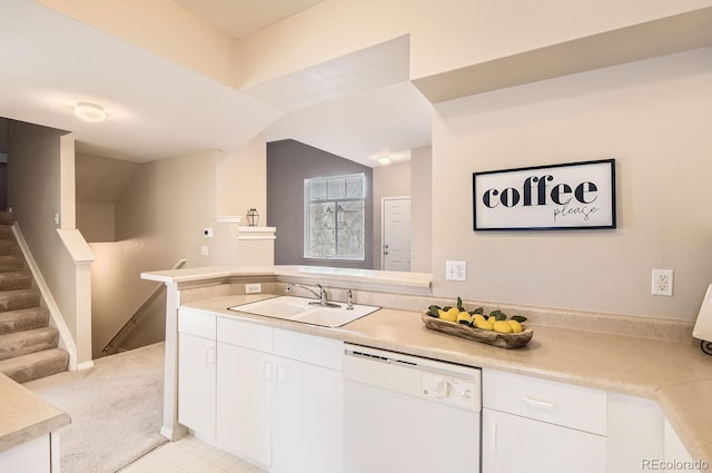 kitchen featuring sink, white cabinetry, white dishwasher, light colored carpet, and kitchen peninsula