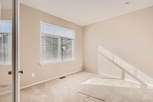 carpeted empty room featuring a healthy amount of sunlight