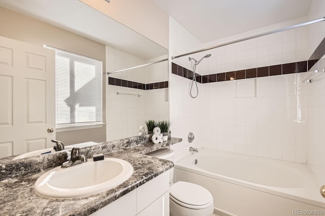 full bathroom with vanity, toilet, and tiled shower / bath combo