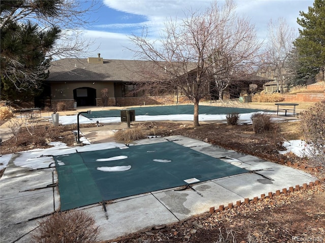 view of pool featuring a diving board