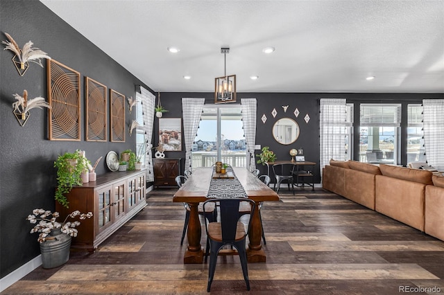 dining space with a notable chandelier and dark wood-type flooring