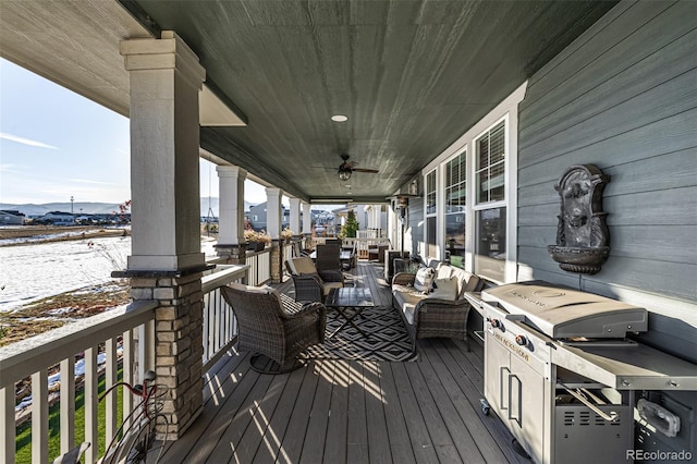 snow covered deck featuring a porch