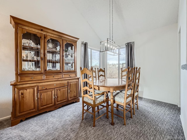 carpeted dining space with lofted ceiling and a chandelier