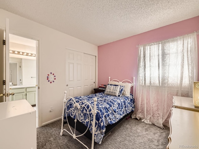 bedroom featuring a textured ceiling, dark carpet, and a closet