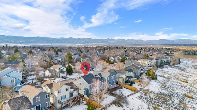 snowy aerial view with a mountain view