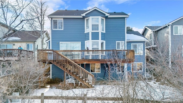 snow covered property featuring a wooden deck