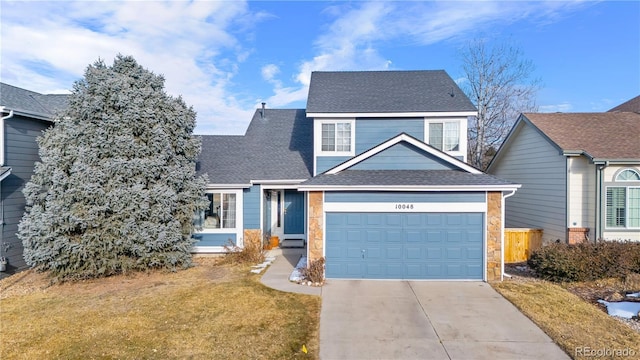 view of front of home with a garage and a front yard