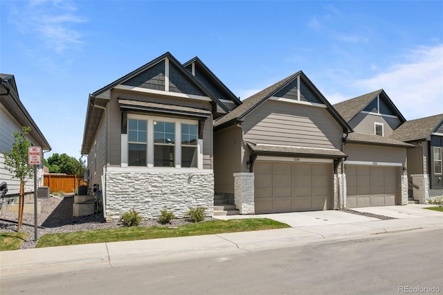 11341 W Alder Dr, Littleton, CO 80127 - craftsman house with stone siding, a garage, and driveway