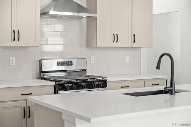11341 W Alder Dr, Littleton, CO 80127 - kitchen with stainless steel gas range oven, wall chimney exhaust hood, light countertops, and backsplash