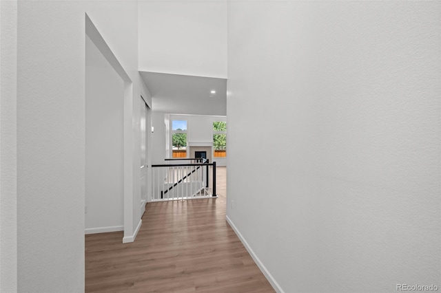 11341 W Alder Dr, Littleton, CO 80127 - corridor featuring wood finished floors and an upstairs landing