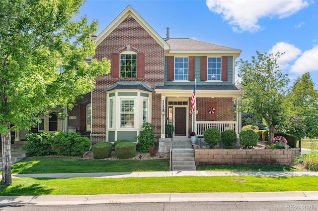 8318 Devinney Ct, Arvada, CO 80005 - view of front of house featuring a porch, brick siding, and a front yard