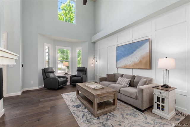 8318 Devinney Ct, Arvada, CO 80005 - living area featuring dark wood-type flooring, plenty of natural light, and a high ceiling
