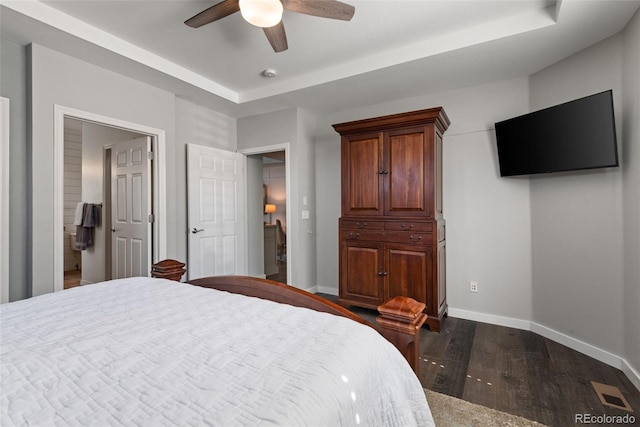 8318 Devinney Ct, Arvada, CO 80005 - bedroom featuring dark wood finished floors, a tray ceiling, and ceiling fan