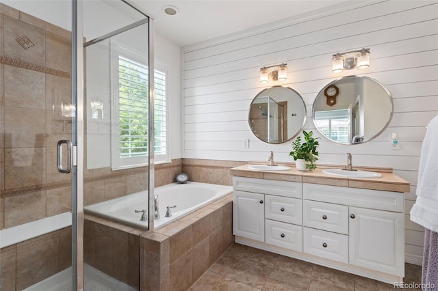 8318 Devinney Ct, Arvada, CO 80005 - full bathroom with double vanity, a garden tub, a stall shower, and tile patterned flooring