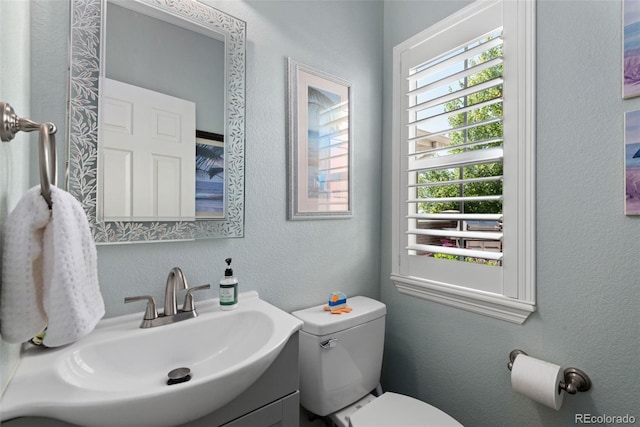 8318 Devinney Ct, Arvada, CO 80005 - half bath featuring vanity and a textured wall
