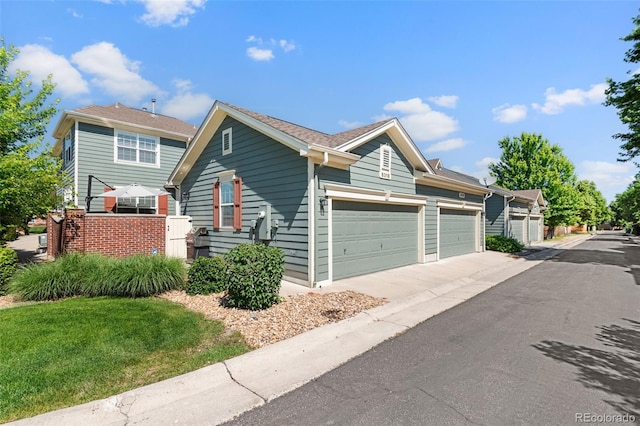 8318 Devinney Ct, Arvada, CO 80005 - view of front of home featuring an attached garage and driveway