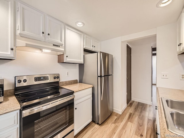 kitchen featuring white cabinetry, sink, light hardwood / wood-style flooring, and stainless steel appliances