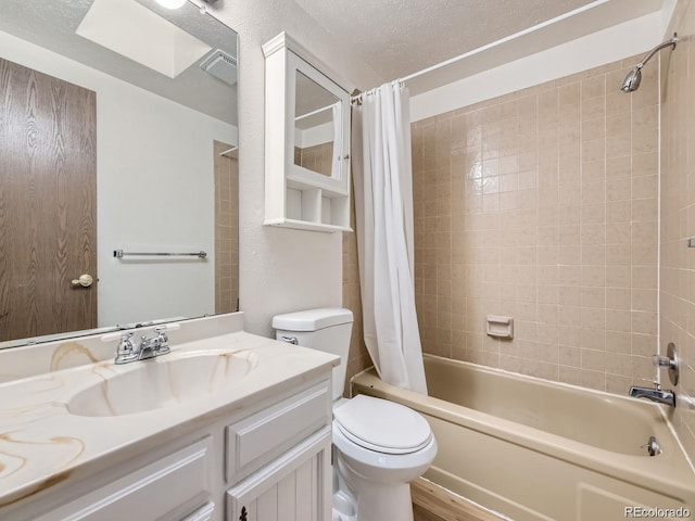 full bathroom with vanity, shower / tub combo, a textured ceiling, and toilet