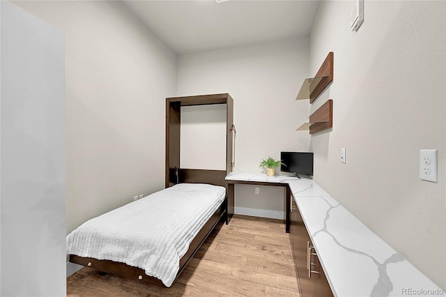 bedroom with light wood finished floors
