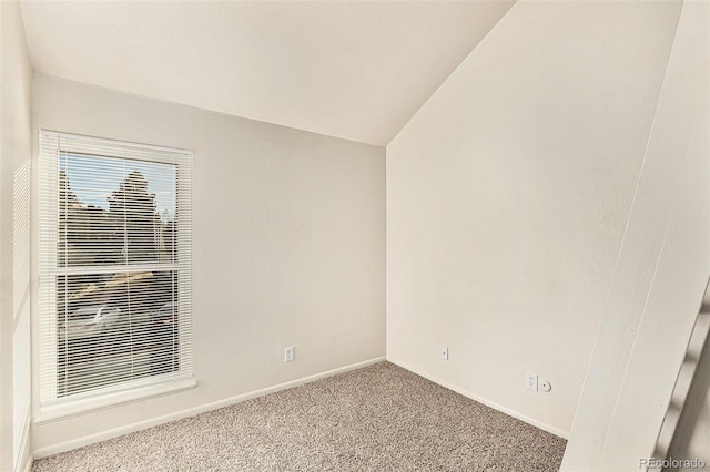 empty room featuring lofted ceiling and light carpet