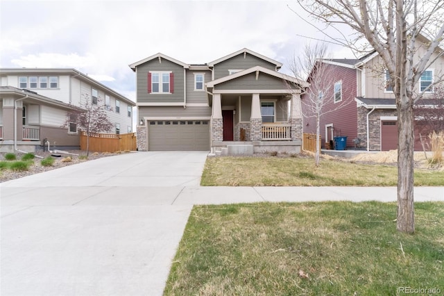 craftsman house featuring an attached garage, stone siding, driveway, and a front lawn