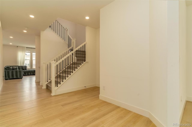 interior space featuring recessed lighting, baseboards, and wood finished floors