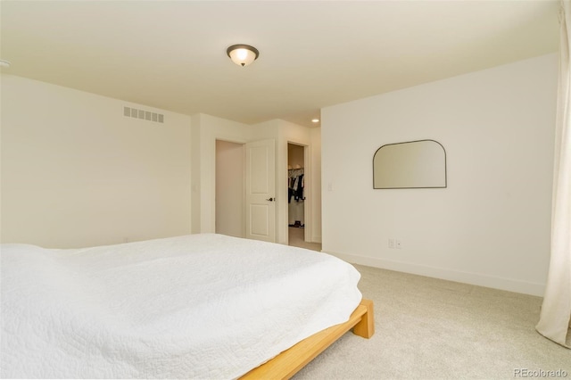 bedroom featuring baseboards, visible vents, and light colored carpet