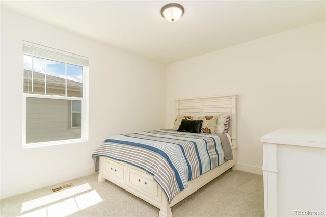 bedroom featuring light carpet, visible vents, and baseboards